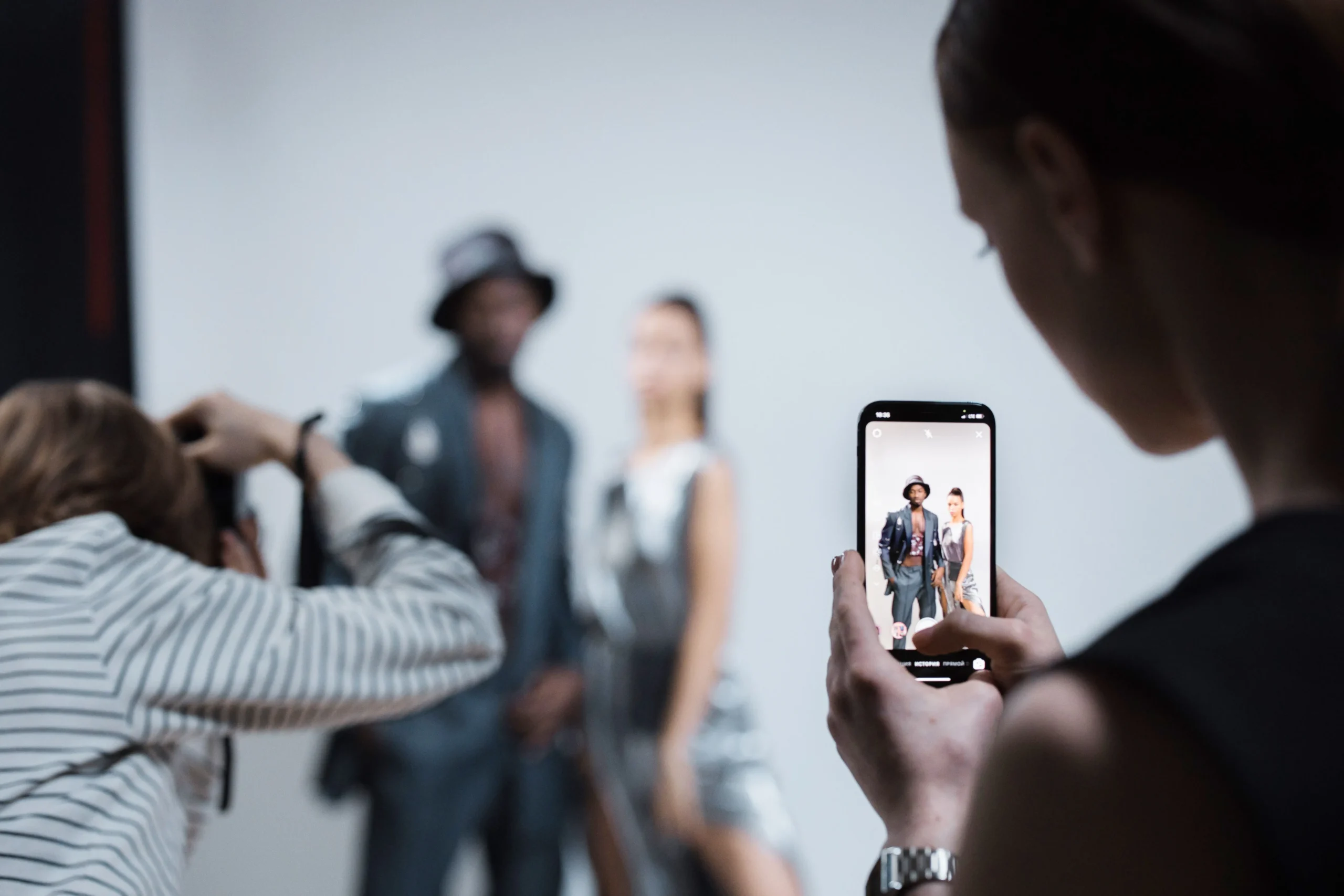 social media photoshoot with woman holding a phone in the foreground